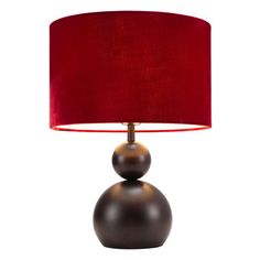 a table lamp with a red shade on the base and a black ball underneath it