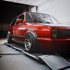 a red car is parked in a garage