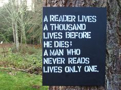 a sign on the side of a tree that says, a reader lives a thousand lives before he dies a man who never reads lives only one