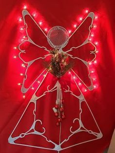 a lighted christmas angel decoration on a red background