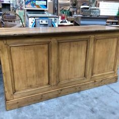 a large wooden counter sitting inside of a store