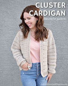 a woman standing in front of a gray wall wearing a crochet cardigan