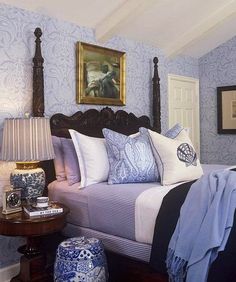 a bedroom with blue and white decor on the walls