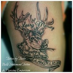 a tattoo with an image of a deer and the words in loving memory on it