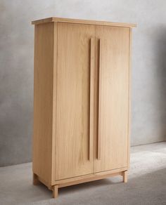 a wooden cabinet sitting on top of a carpeted floor