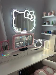 a hello kitty mirror sitting on top of a desk