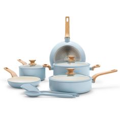 a set of blue pots and pans with wooden spoons next to them on a white background