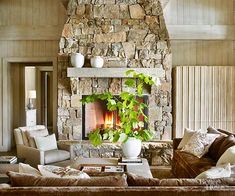 a living room filled with furniture and a fire place next to a wall mounted fireplace