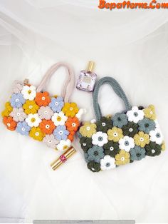 two purses with flowers on them are laying next to each other and one has a lighter in it