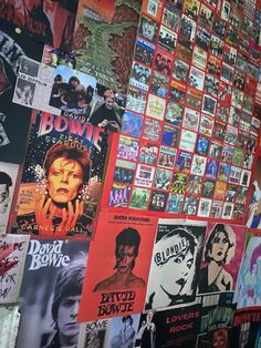 the wall is covered with posters and advertisements for various shows, movies, and films