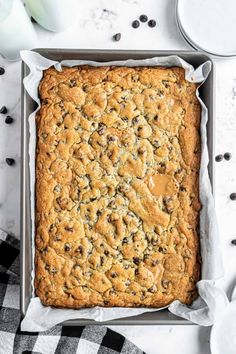 a pan filled with chocolate chip cookie bars on top of a table