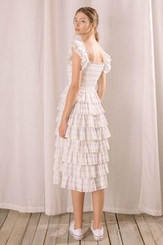 This gingham dress exudes cottage core and romantic elegance. It features a square neckline, smocked fitted upper body, and flounce and ruffled capped sleeves. Its tiered ruffles start at the waist and cascade to mid-length. Comfort and chic style come together to create the perfect look. Material:Polyester Cottagecore Square Neck Dress With Ruffle Hem, Cottagecore Ruffled Dresses For Brunch, Square Neck Dress With Ruffle Hem For Picnic, Midi Length Smocked Dress With Ruffles For Garden Party, Midi-length Smocked Dress With Ruffles For Garden Party, Ruffled Midi Length Smocked Dress For Garden Party, Summer Plaid Dress With Square Neck And Ruffles, Square Neck Plaid Dress For Picnic, Feminine Ruffled Dress For Picnic