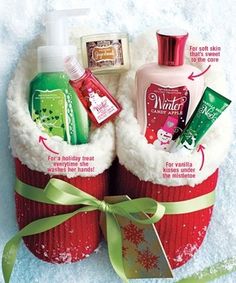 two red baskets filled with personal care items in the snow and wrapped in green ribbon