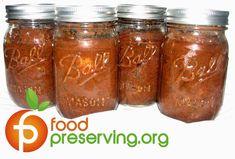 four jars filled with food sitting next to each other