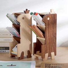 the wooden toy horse is next to some books