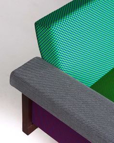 an upholstered bench with three different colored fabrics on the seat and backrests