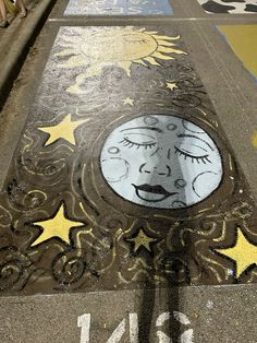 the sidewalk has been painted with stars and moon designs