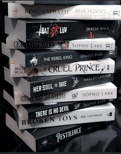 a stack of books sitting on top of each other in front of a black background