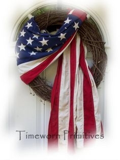 a wreath with an american flag draped over it