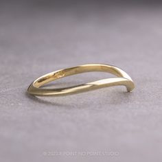 a close up of a gold ring on a table