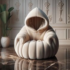 a white sculpture sitting on top of a table next to a vase and potted plant