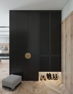 a room with black walls and wooden floors has shoes on the floor next to it