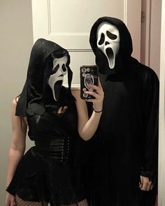 two people dressed up in costumes taking a selfie