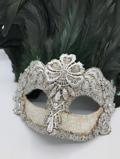 Masquerade mask with feathers made with real black and green feathers. Decorated with macrame tecnique with Burano Lace,silver leaf and swarovski Size: one size All our masks are handmade papier-machè masks made in Venice. Our decorators use techniques typical of the Venetian tradition such as stucco, acrylics, gold and silver-leaf, macramè, passementerie, pearls and crequelè to give you a wide range of masks. We ship worldwide with GLS, DHL, FedEx. Very accurate packaging. Tracked shipment and Burano Lace, Mascara Papel Mache, Mask With Feathers, Green Feathers, Venice Mask, Venetian Carnival Masks, Venetian Carnival, Half Mask, Venetian Mask