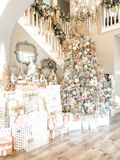 a decorated christmas tree sitting in the middle of a living room next to boxes and presents