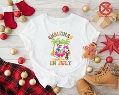 Christmas in July Shirt, Santa at the Beach,Summer Santa T-shirt,Christmas in Summer Gift,Hawaiian Santa Shirt,Tropical Christmas Shirt Gift 👌HOW TO ORDER 1-) Please, check and review all the photos. 2-) Choose your t-shirt size and color. *Different styles of shirts may have different shades of same color choice due to different manufacturer brands. *For this reason, we recommend you to match shirts from the same styles if you want precisely matching colors (ex. Unisex, V-necks, Toddler, etc.) White T-shirt For Vacation, White Summer Holiday T-shirt, Fun T-shirt For Beach Season Holiday, White T-shirt For Beach Holiday, Beach Season Holiday Cotton T-shirt, Beach Holiday Cotton T-shirt, Graphic Print T-shirt For Beach Holiday, Beach Holiday Graphic Print T-shirt, Cotton T-shirt For Beach Holiday