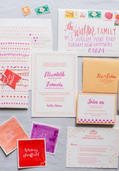 the wedding stationery is laid out on top of each other, including envelopes and cards