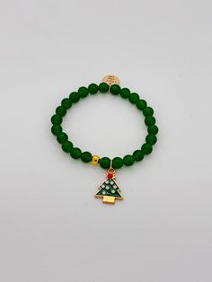 Green beads and gold accent beads with a Christmas Tree charm bracelet. Adorable by itself or stacked with a few other holiday bracelets! $18 By Little Miss Zoe Cheap Green Holiday Bracelets, Cheap Holiday Beaded Bracelets For Gift, Gold Beaded Christmas Bracelets, Adjustable Gold Beaded Bracelets For Holiday, Festive Green Beaded Bracelets With Colorful Beads, Christmas Holiday Beaded Bracelets With Colorful Beads, Christmas Beaded Stretch Bracelet Gift, Gold Beaded Bracelets For Christmas, Festive Green Beaded Bracelets