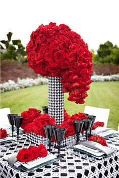 a black and white table with red roses on it