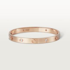 Cartier - LOVE bracelet, 4 diamonds - Bracelet Gold - LOVE bracelet, 18K rose gold (750/1000), set with 4 brilliant-cut diamonds totaling 0.42 carats. Comes with a screwdriver. Width: 6.1 mm. Created in New York in 1969, the LOVE bracelet is an icon of jewelry design: a close fitting, oval bracelet composed of two rigid arcs which is worn on the wrist and removed using a specific screwdriver. The closure is designed with two functional screws placed on either side of the bracelet: you will need Luxury Bracelet, Bracelet Love, Love Bracelet, Cartier Love, Diamonds And Gold, Gold Plated Bracelets, Bracelet Collection, Cartier Love Bracelet, Love Bracelets