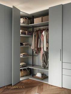 an open closet with clothes and bags on shelves