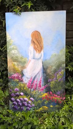 a painting of a girl in a white dress is on the ground surrounded by flowers