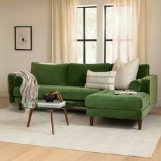 a living room with a green couch and white rug