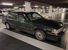 a green car parked in a parking garage