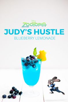 a blueberry lemonade cocktail in a tall glass with an animal figurine next to it