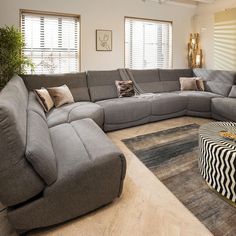 a large sectional couch sitting in the middle of a living room