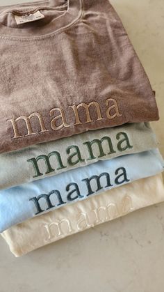 four t - shirts are stacked on top of each other with the word mama printed on them