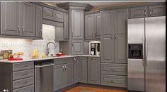 a large kitchen with gray cabinets and stainless steel appliances