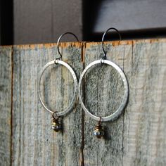 These are hammered Pewter hoops with antiqued Bronze Rhinestone drops on oxidized Sterling Silver ear wire. They hang approximately 2 1/2 inches. Small Metal Hoop Earrings With Soldered Detail, Small Hoop Metal Earrings With Soldered Details, Rustic Hammered Metal Jewelry, Silver Wings, Wing Necklace, Memphis Tn, Pearl Hoop Earrings, Nov 2, Mother Pearl