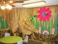 a room decorated with paper flowers and plants