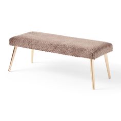 an upholstered bench with wooden legs and a light brown fur cover on it