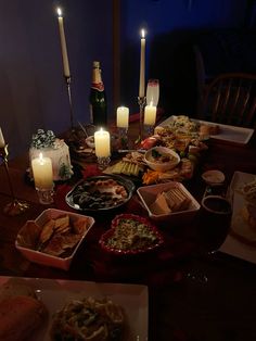 a table full of food and candles on it