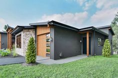 a modern home with two garages on the front and one bedroom in the back