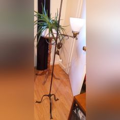 a floor lamp with a plant on top of it