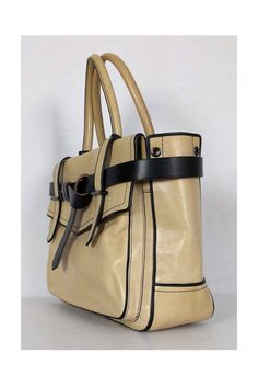 Take this day bag anywhere you go. Designed in a structured shape and with a neutral tan color. It is edgy and modern and will pair well with most daytime looks. Leather Double rolled handles Open top Black leather straps around top of bag 2 exterior pockets 2 interior zip pockets 1 interior slip pocket Width 13" Height 10" Depth 3.75" Handle drop 6" Designer Everyday Satchel With Adjustable Strap, Designer Satchel With Adjustable Strap For Everyday, Beige Double Handle Satchel For Office, Beige Workwear Satchel With Detachable Strap, Chic Workwear Satchel With Handles, Versatile Office Satchel With Leather Handles, Beige Satchel For Office, Modern Beige Satchel With Detachable Strap, Modern Beige Satchel For Everyday