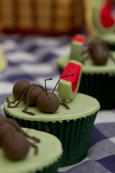 some cupcakes with chocolate bugs on them